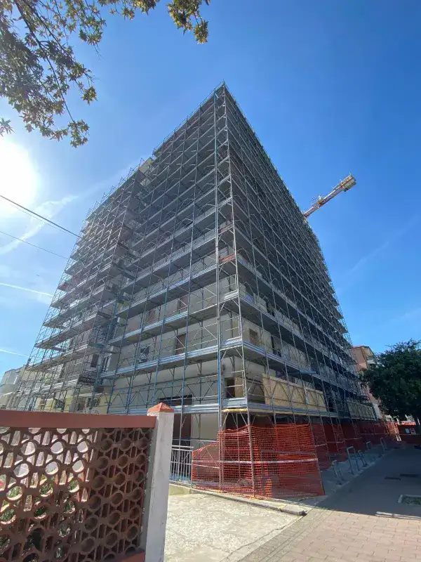 Cantiere 2 — Condominio alto con facciata gialla